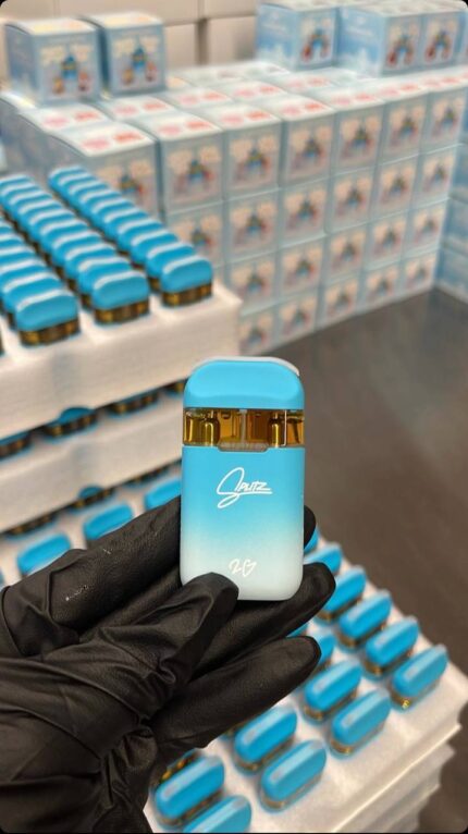 A gloved hand holding a Splitz disposable with dual chambers.